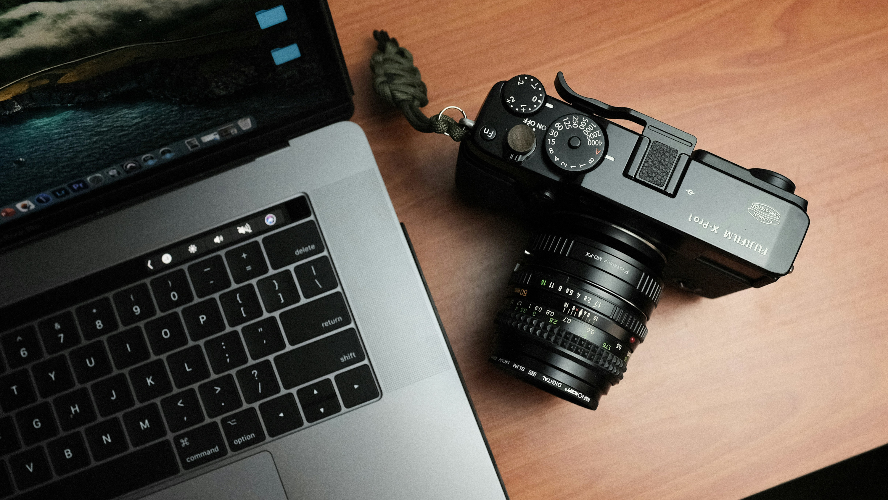 Closeup of content creation tools, including a laptop and digital SLR camera